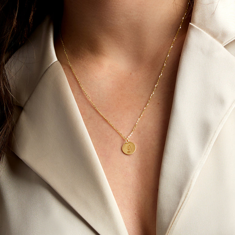 Yellow gold chain necklace with small round monogram disc charm