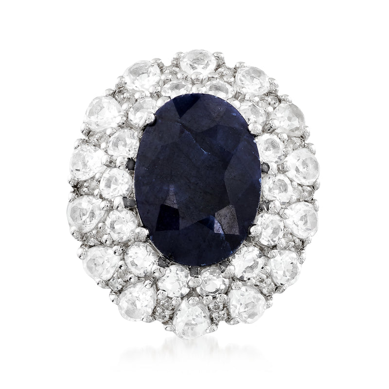 Sterling silver ring with oval dark blue sapphire center and white topaz halo