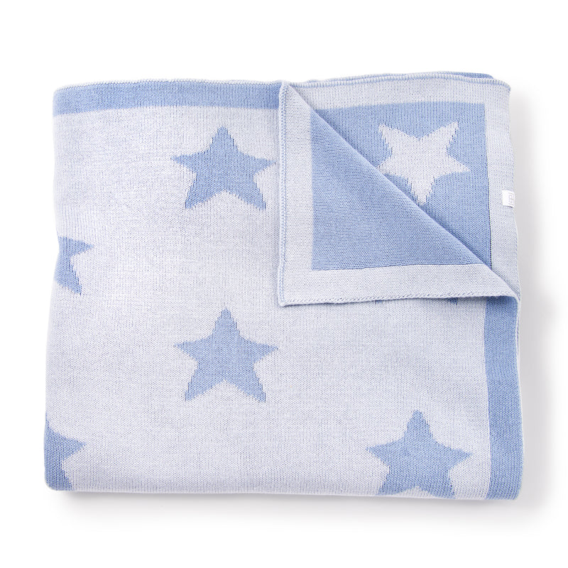 Cotton baby blanket in light blue and white with scattered blue star print, folded