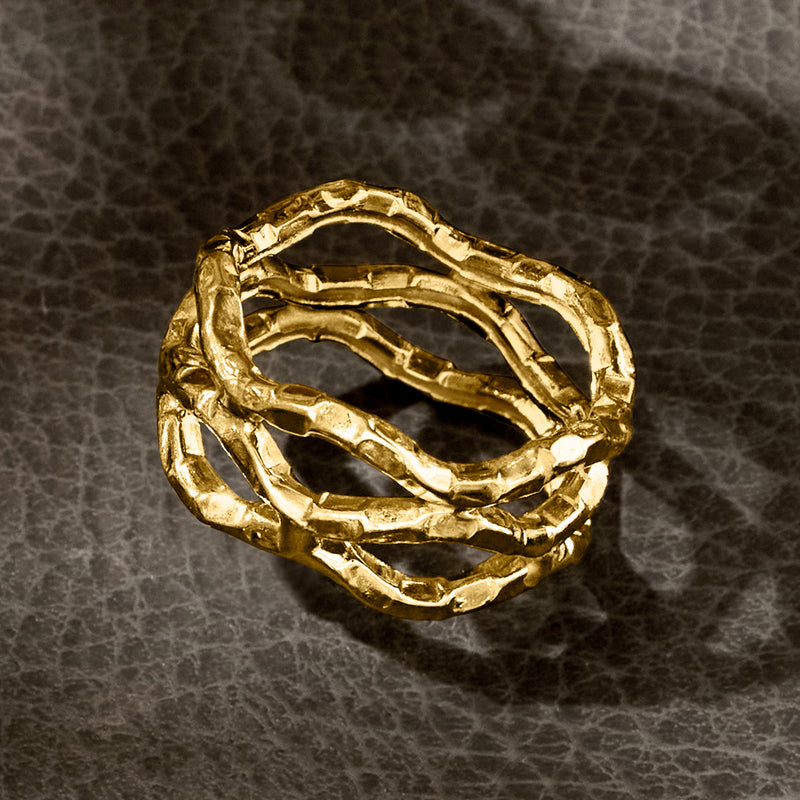 Textured 14kt yellow gold wavy open-space ring, top view with layered curves
