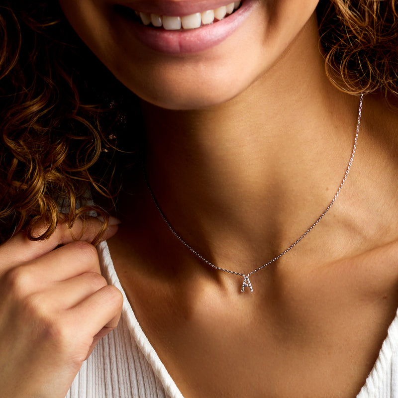 Sterling silver diamond initial necklace with letter A pendant and link chain.