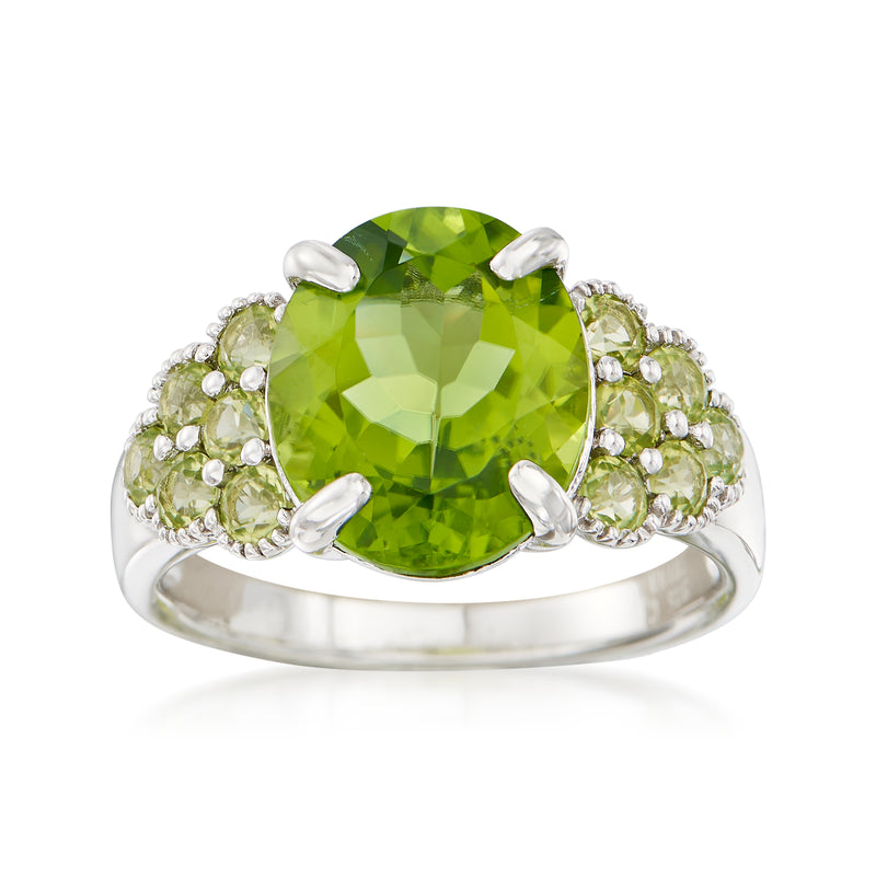 Peridot ring in sterling silver with oval center stone and side peridot clusters