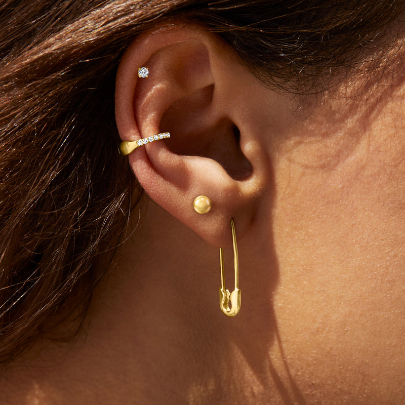 14kt yellow gold round diamond stud earrings on ear