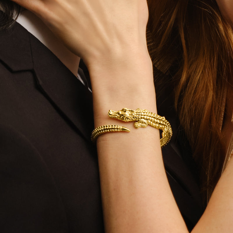 Alligator bangle bracelet in yellow gold worn on wrist with textured links