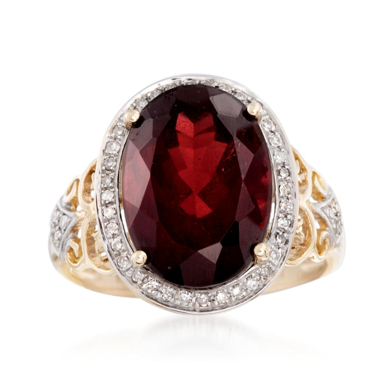 Garnet and diamond halo ring in 14kt yellow gold, dark red oval center stone