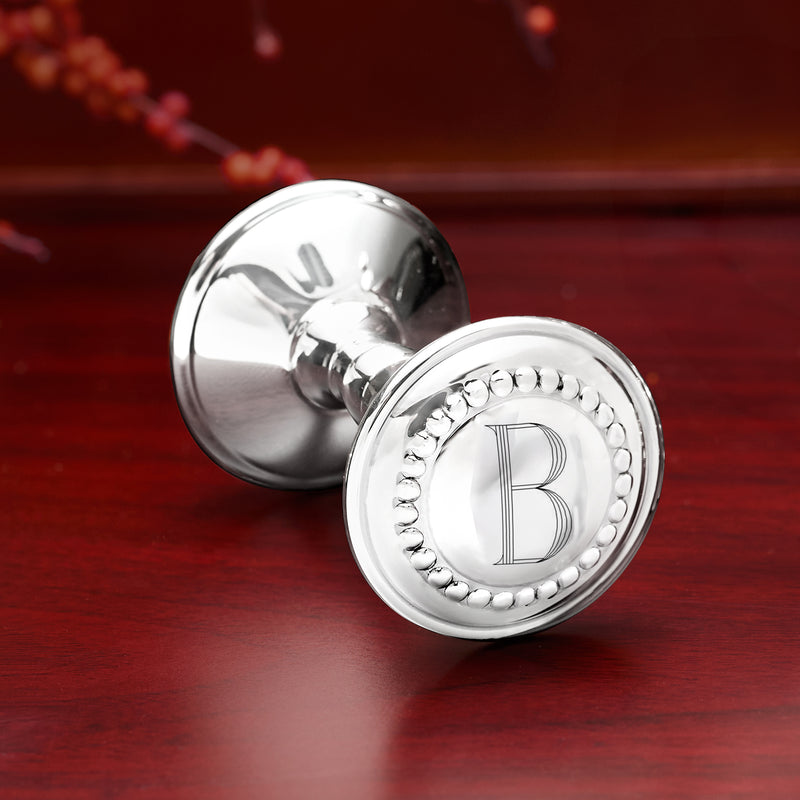 Sterling silver baby rattle showing round initial B medallion with beaded edge