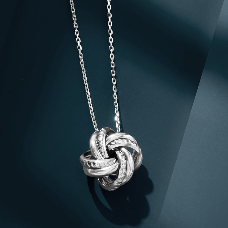 Sterling silver love knot pendant on slim chain, glossy twisted links