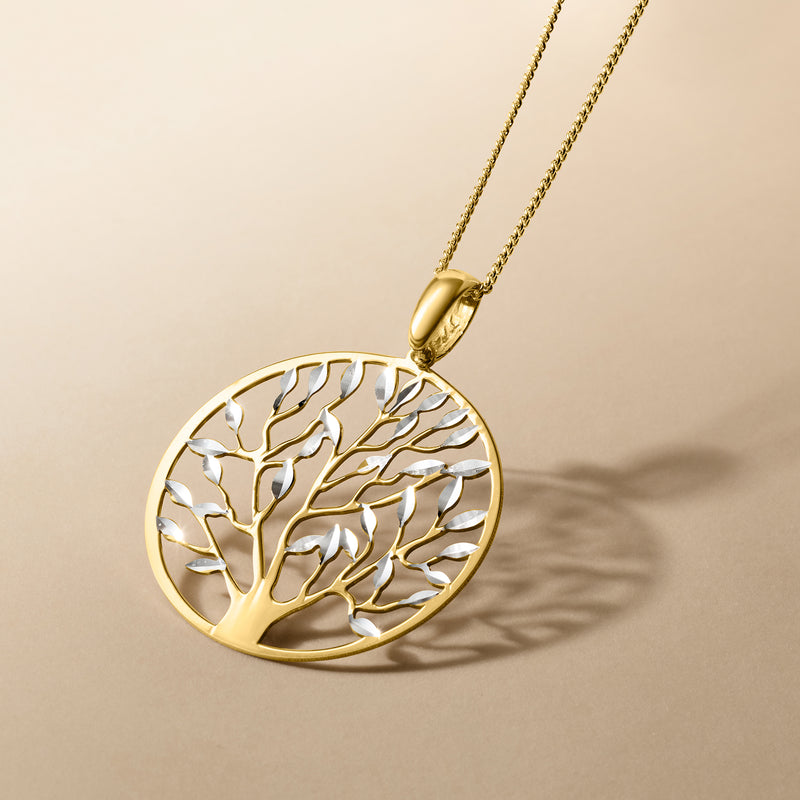 Round Tree of Life pendant necklace with gold-tone bezel, hanging on chain