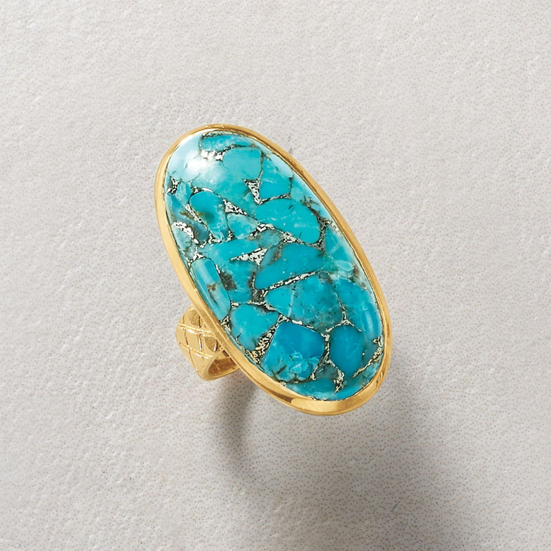 Oval turquoise ring with gold-toned bezel and silver-toned veining, side view