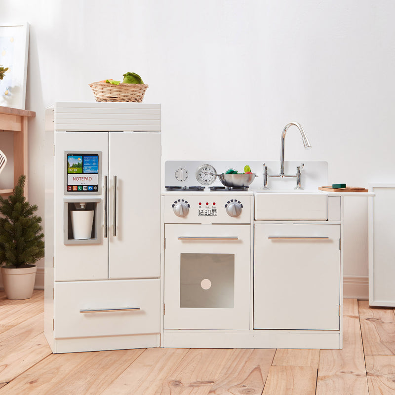 White modern kids play kitchen with oven, stovetop, and sink faucet