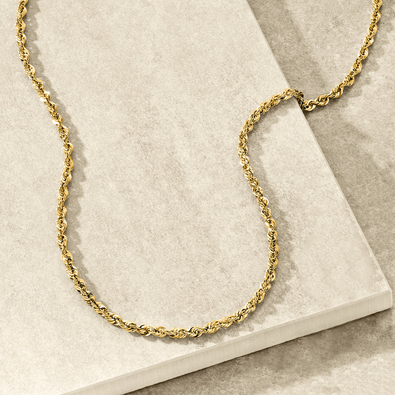 14kt yellow gold rope-chain necklace displayed on a base, twisted rope links