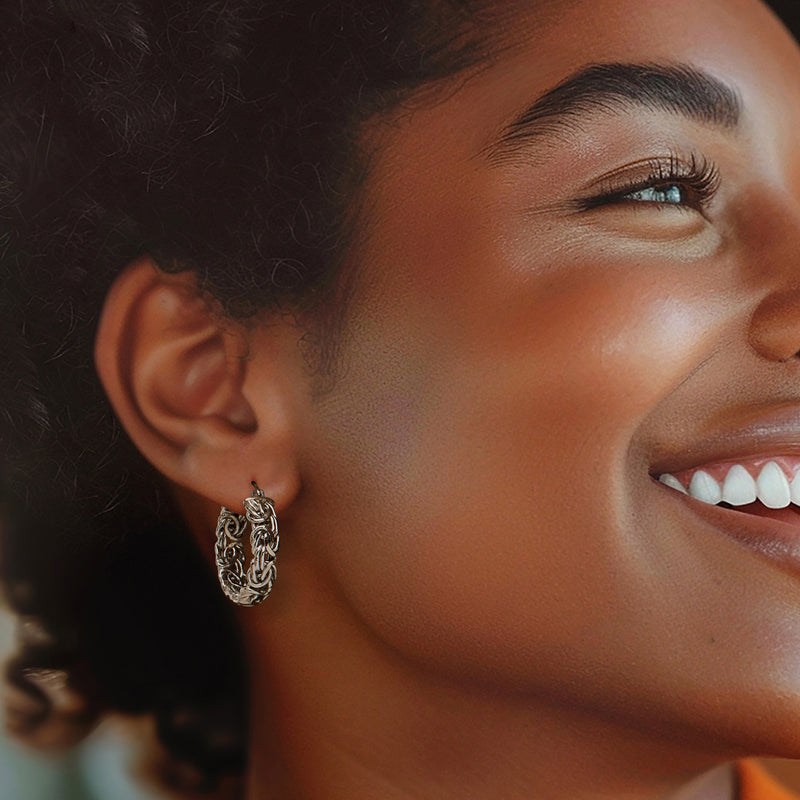 Sterling silver small hoop earrings on model, Byzantine textured oval hoops