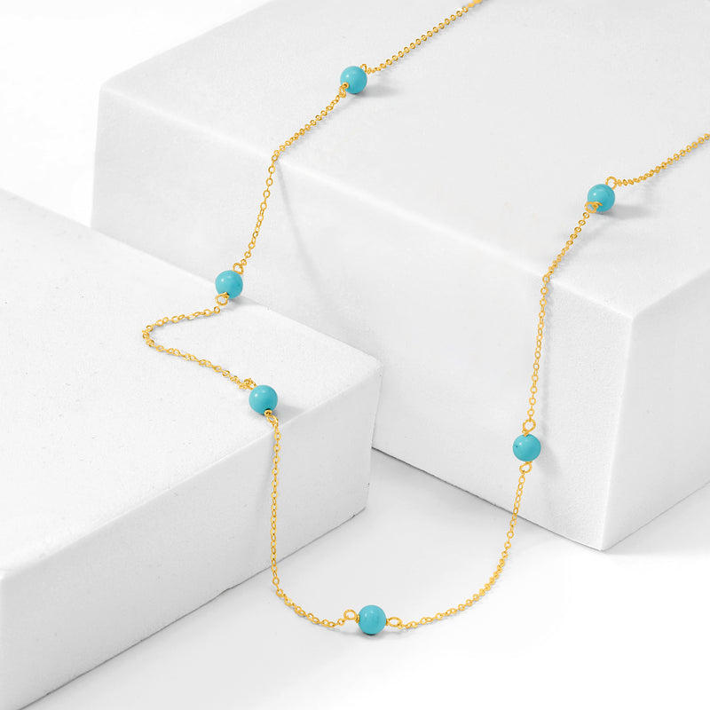Turquoise bead station necklace angled; round blue beads on 14kt yellow gold chain