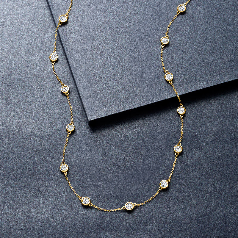 14kt yellow gold diamond station necklace with round bezel-set stations, close view
