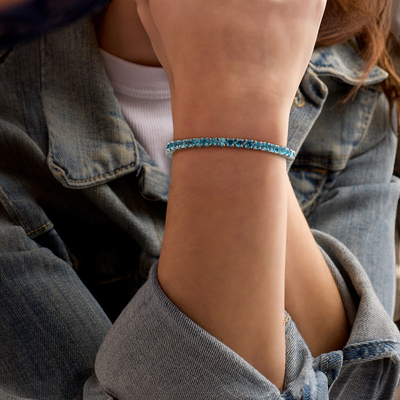London blue topaz tennis bracelet on wrist, sterling silver with small round stones