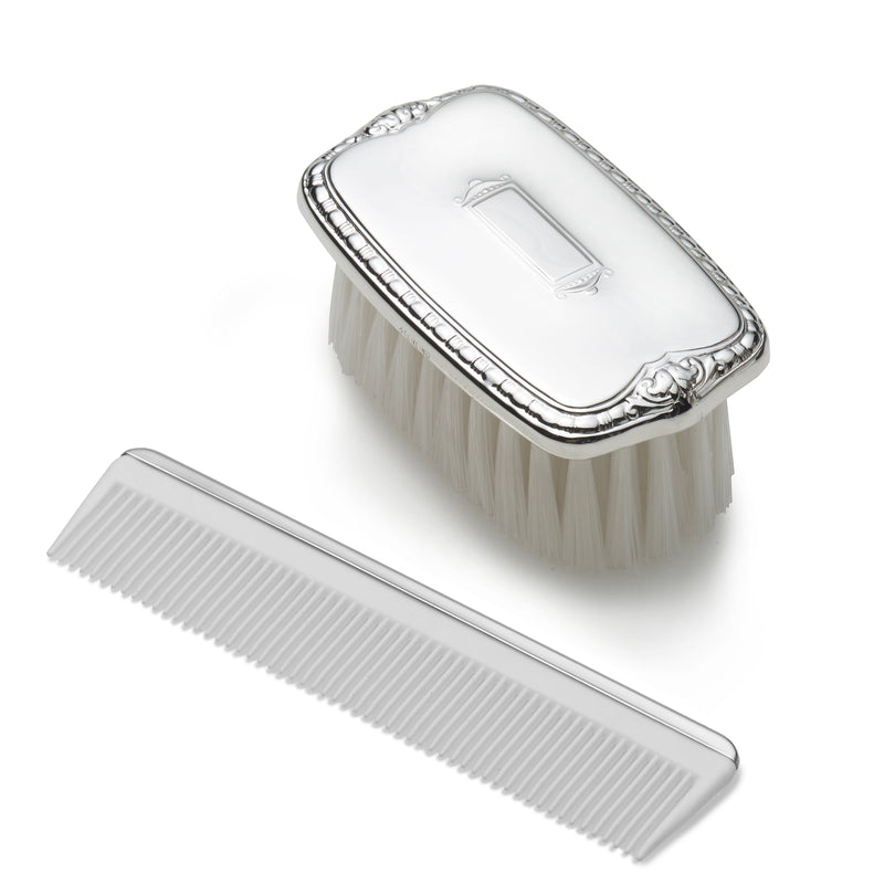 Pewter child’s shield brush and comb set with embossed emblem, matching comb teeth