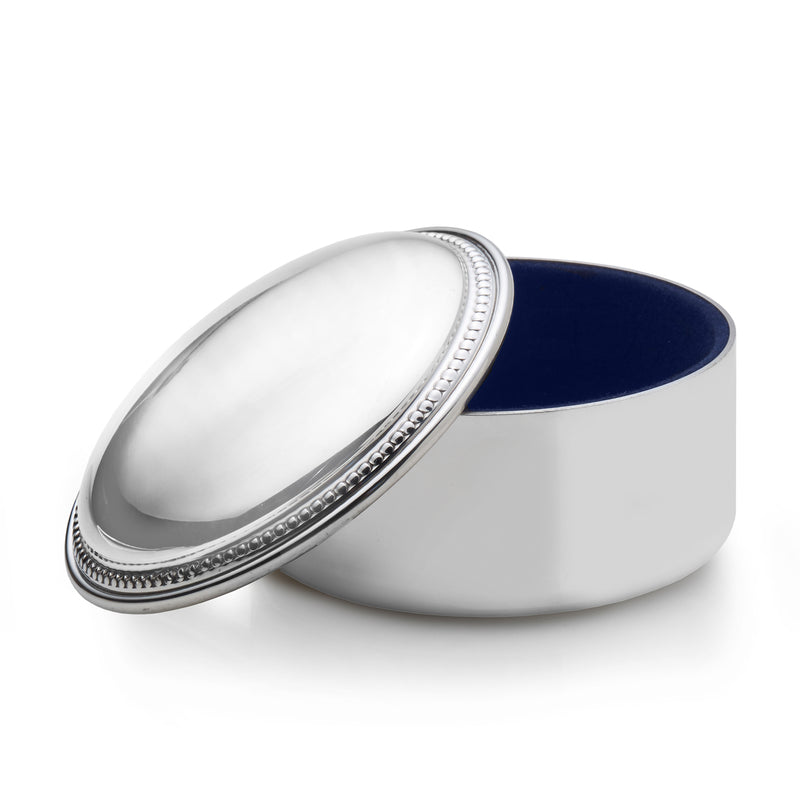 Round pewter beaded jewelry box with hinged lid, open to reveal dark blue interior.