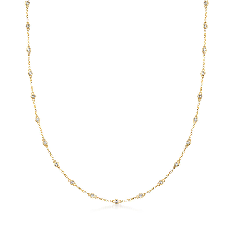 14kt yellow gold station necklace with small bezel-set round diamonds along the chain