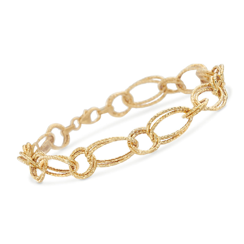 Textured oval and circle link bracelet in 14kt yellow gold.