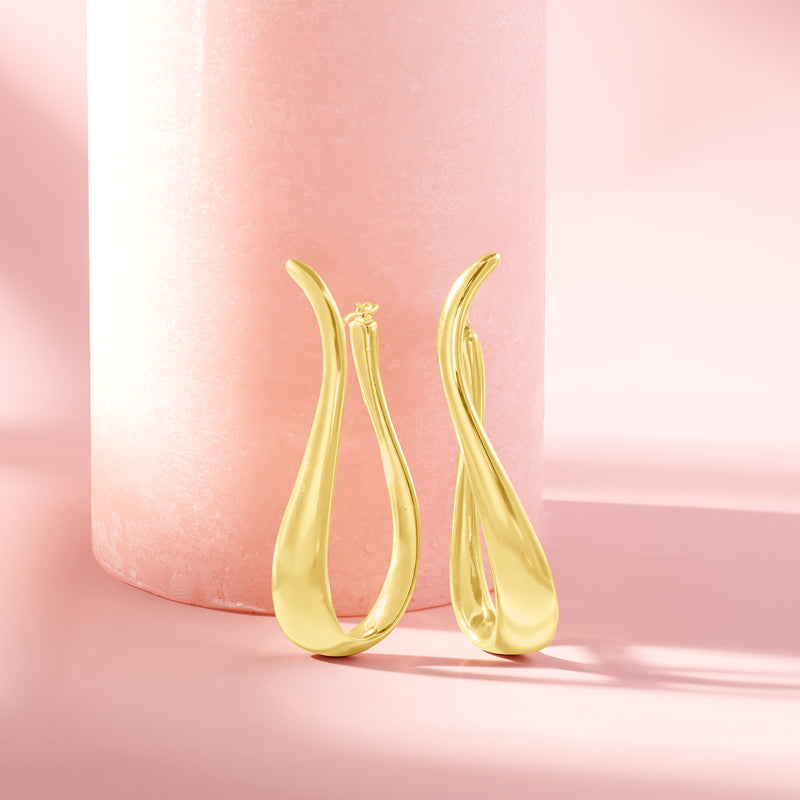Twisted gold hoop earrings with hinged closure, glossy teardrop loop shape