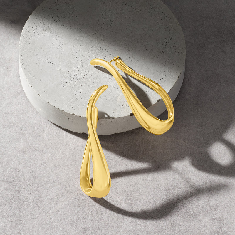 Twisted gold hoop earrings with open back, glossy teardrop loop profile