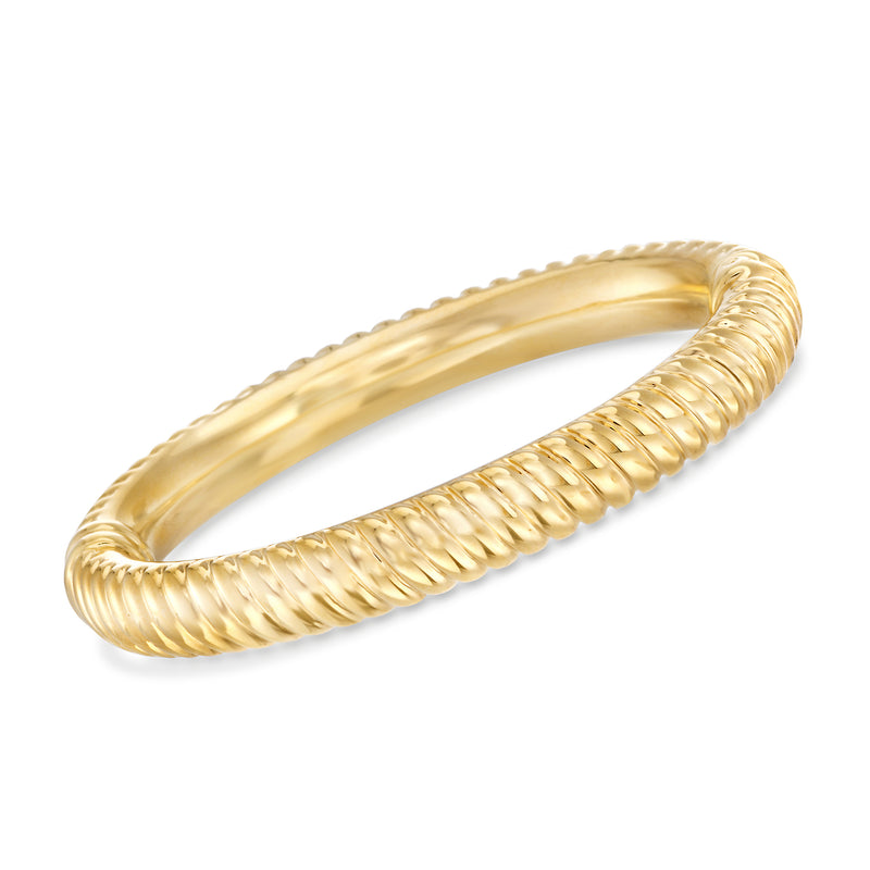 Yellow gold ribbed bangle bracelet with twisted rope-like ridges, open cuff design