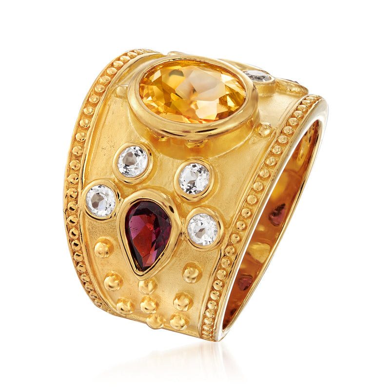 Gold-tone ring side view with oval citrine top, dark red oval gem, and white accents