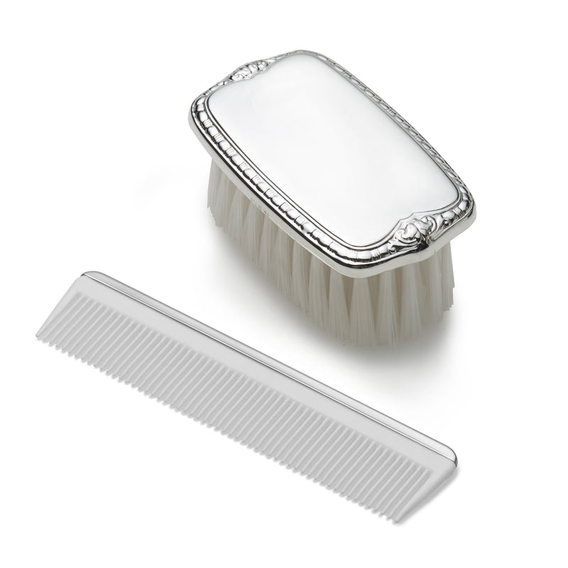 Sterling silver child brush and comb set with ornate handles, white bristles, fine teeth