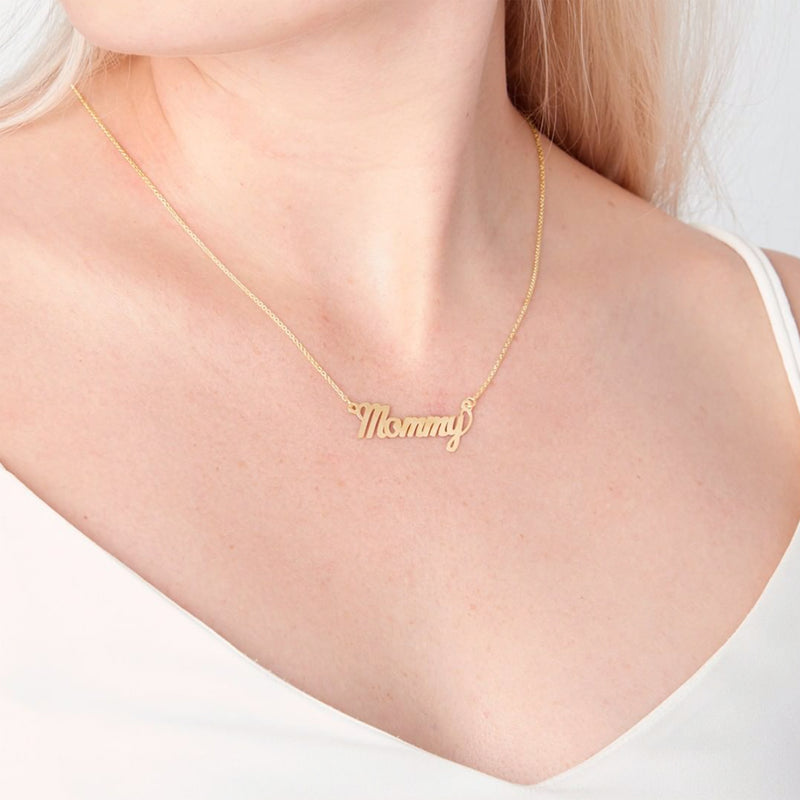 Yellow gold cursive name pendant on fine chain necklace worn on neck