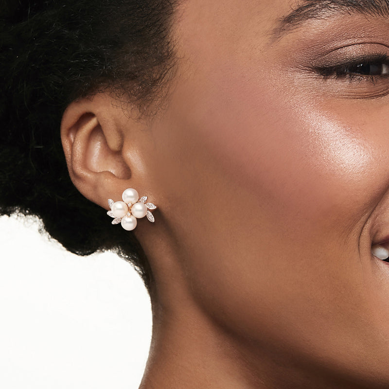 Cultured pearl cluster earrings on model's ear with white pearls and crystal accents