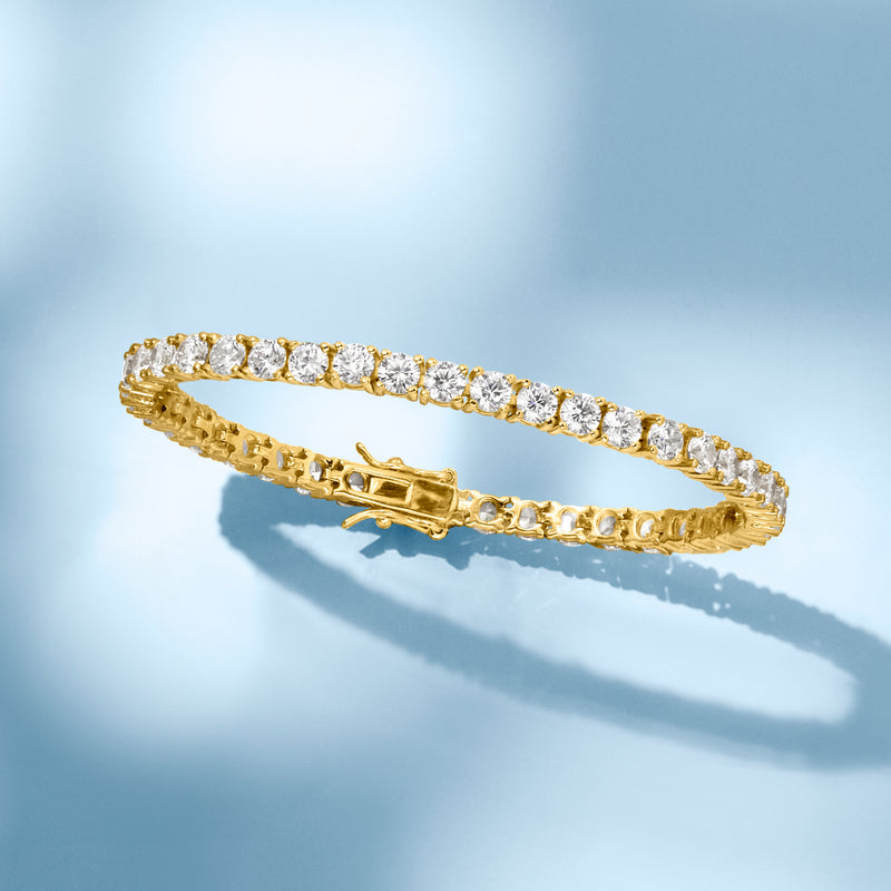 Gold tennis bracelet with round CZ stone row and oval bar clasp, angled view
