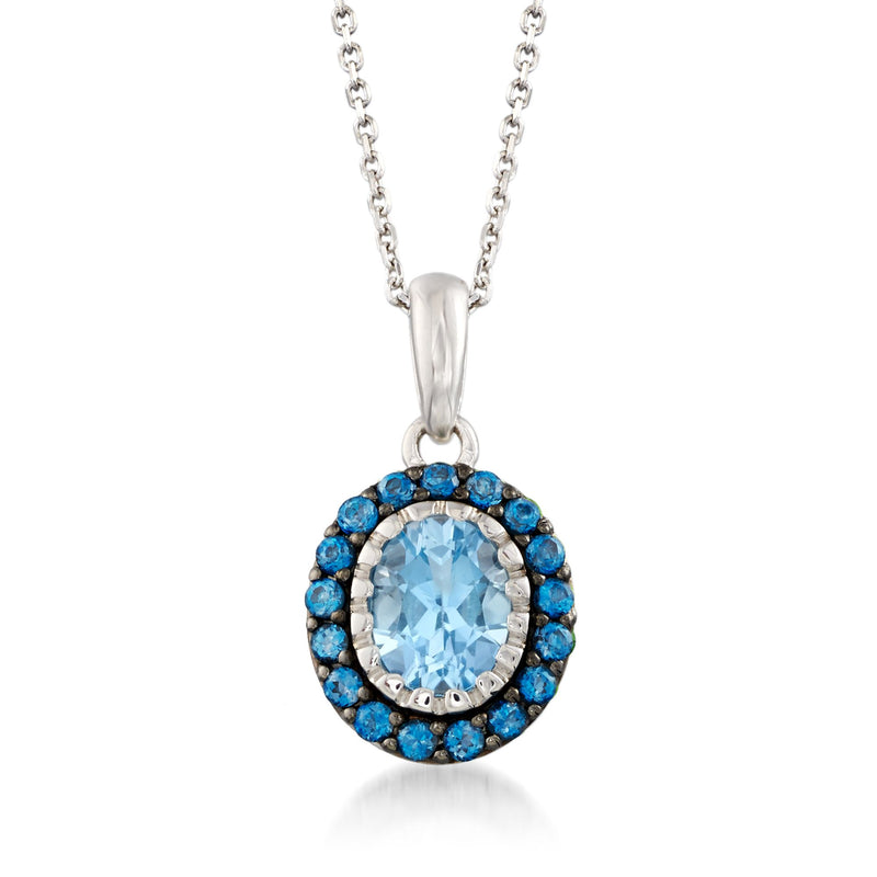 Sterling silver pendant necklace with oval light blue topaz center and dark blue halo