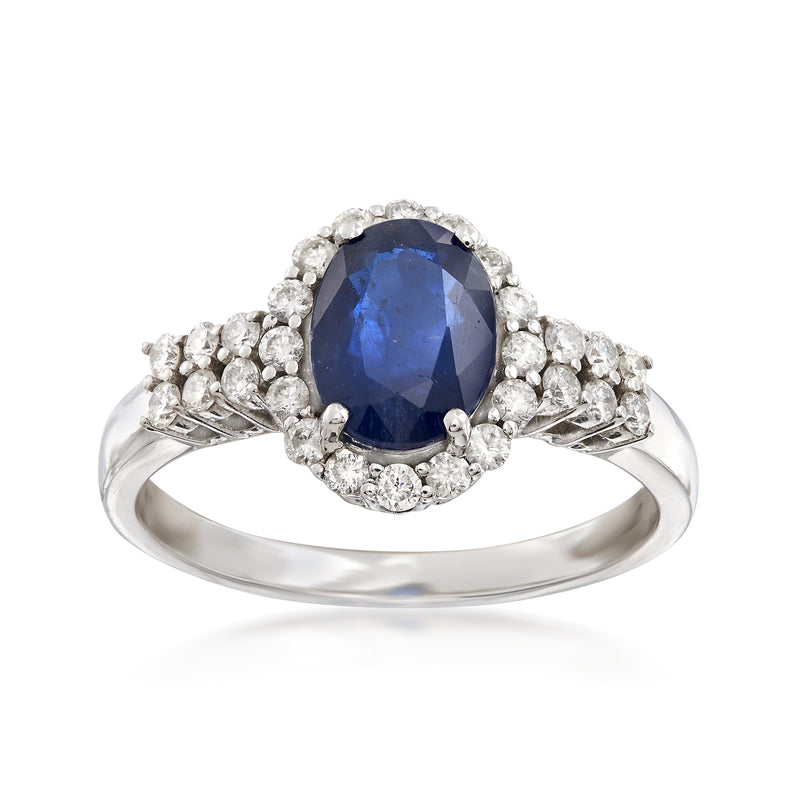 14kt white gold ring with oval blue sapphire center and diamond halo cluster sides