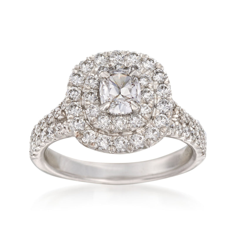 White gold diamond engagement ring with cushion-cut center and round halo