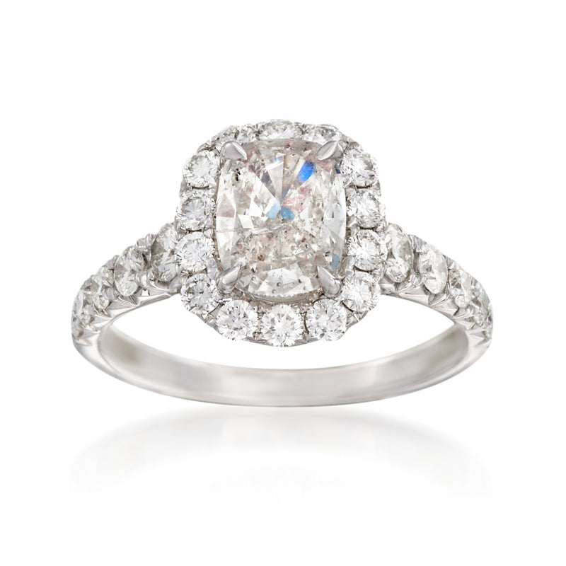Diamond engagement ring in white gold with round halo and prong-set center stone