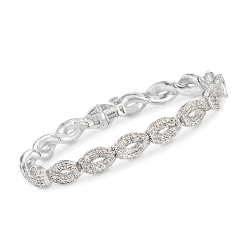 Sterling silver diamond link bracelet with oval cluster stations and hinged clasp