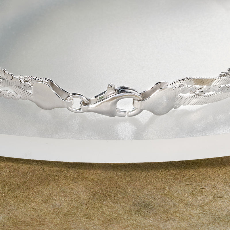 Sterling silver braided bracelet with toggle-style clasp and polished links