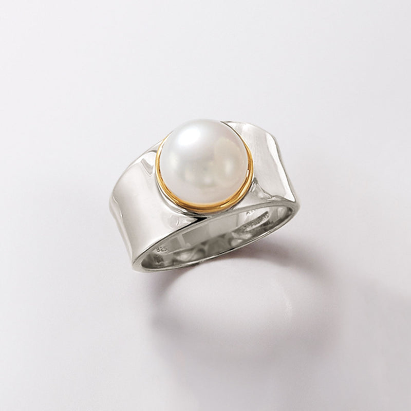 Sterling silver cultured pearl ring with 14kt gold edge setting, angled view