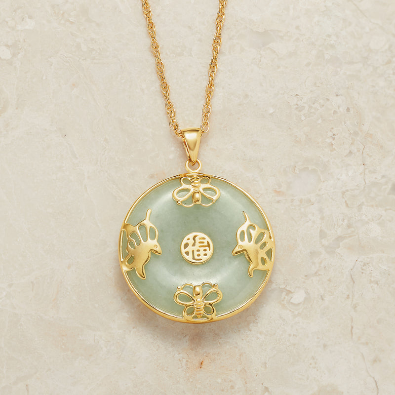 Round jade butterfly pendant necklace on gold chain with floral top and center medallion