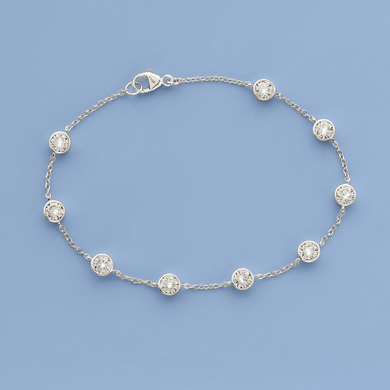 Sterling silver CZ station bracelet with round bezel-set stones along slim chain