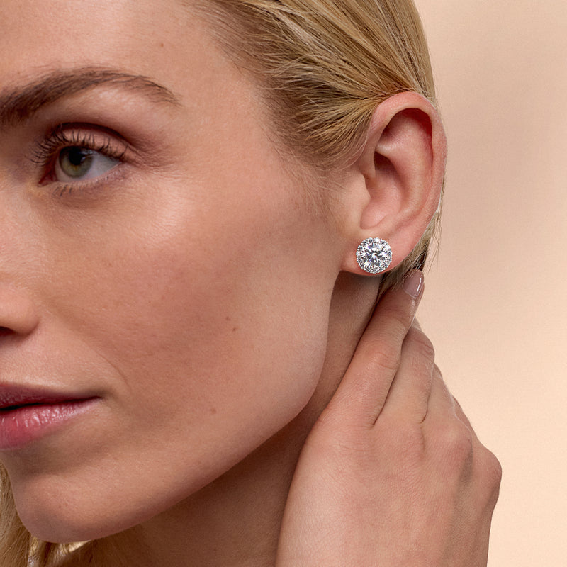 Round CZ stud earrings in sterling silver, worn with post backs visible