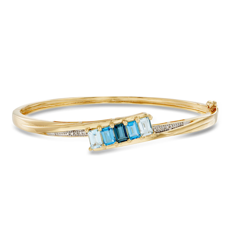 Gold bangle bracelet with rectangular blue topaz and diamond accents
