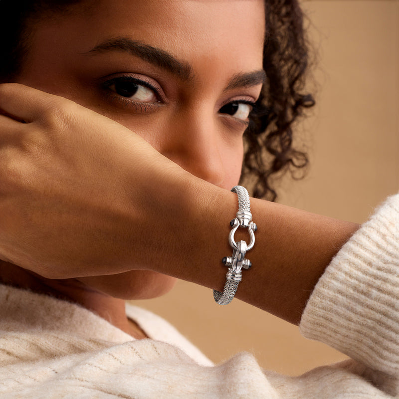 Sterling silver horsebit bracelet with black onyx stones on a wrist