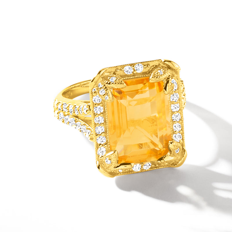 Gold citrine ring with square diamond halo around a yellow gemstone