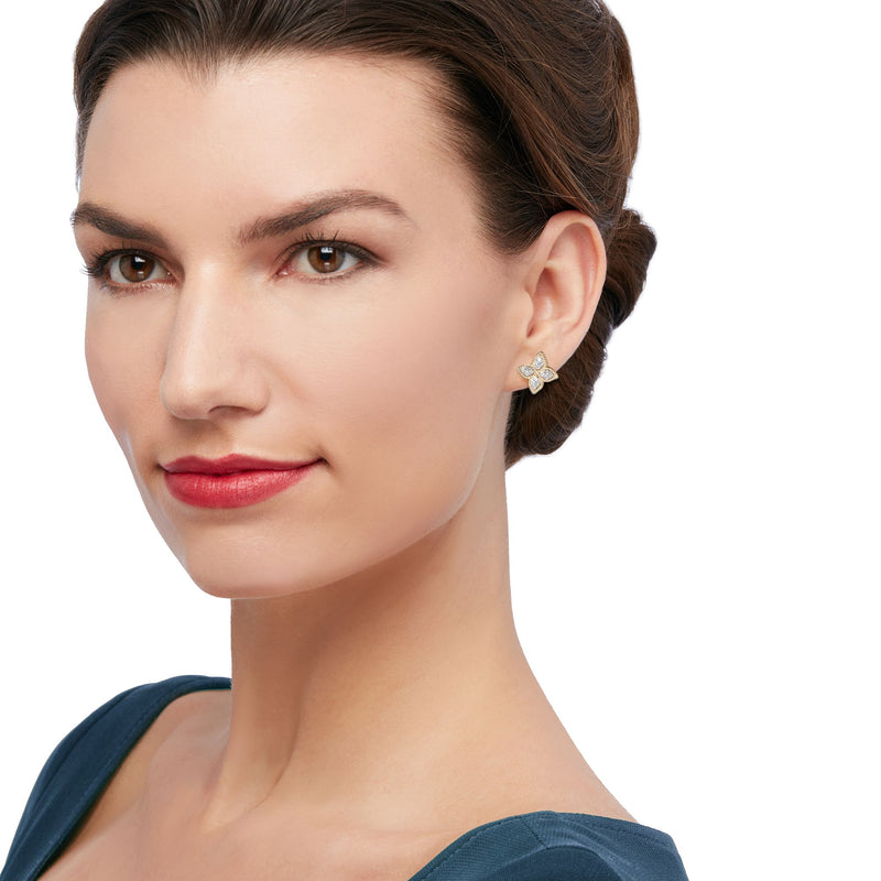 Diamond flower stud earrings on ear, 18kt yellow gold with pear-shaped stones