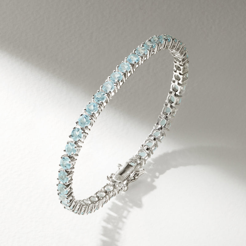 Sky blue topaz tennis bracelet in sterling silver, angled view with clasp