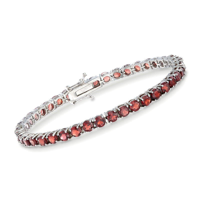 Sterling silver garnet tennis bracelet with row of red oval stones and hinged clasp