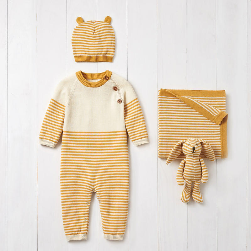Mustard striped knit baby sleeper with matching hat and folded baby outfit set