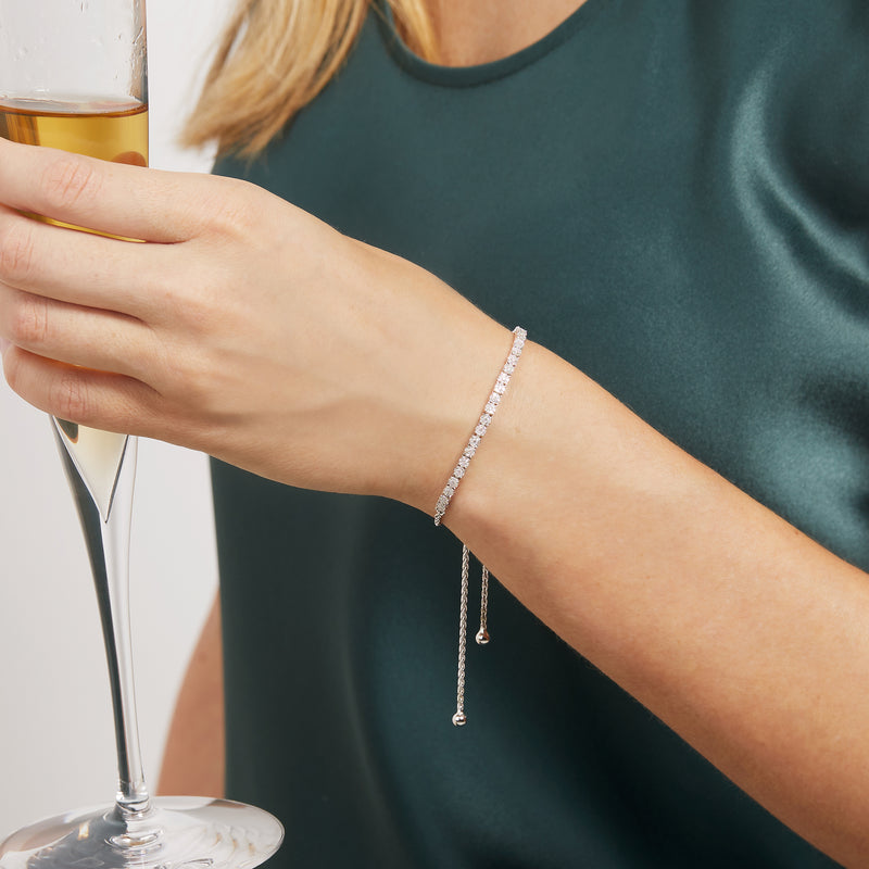 Sterling silver diamond bolo bracelet on wrist with adjustable hanging chain ends