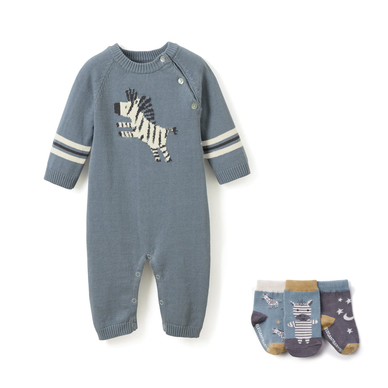 Zebra print knit baby jumpsuit with button front and striped cuffs, plus patterned socks